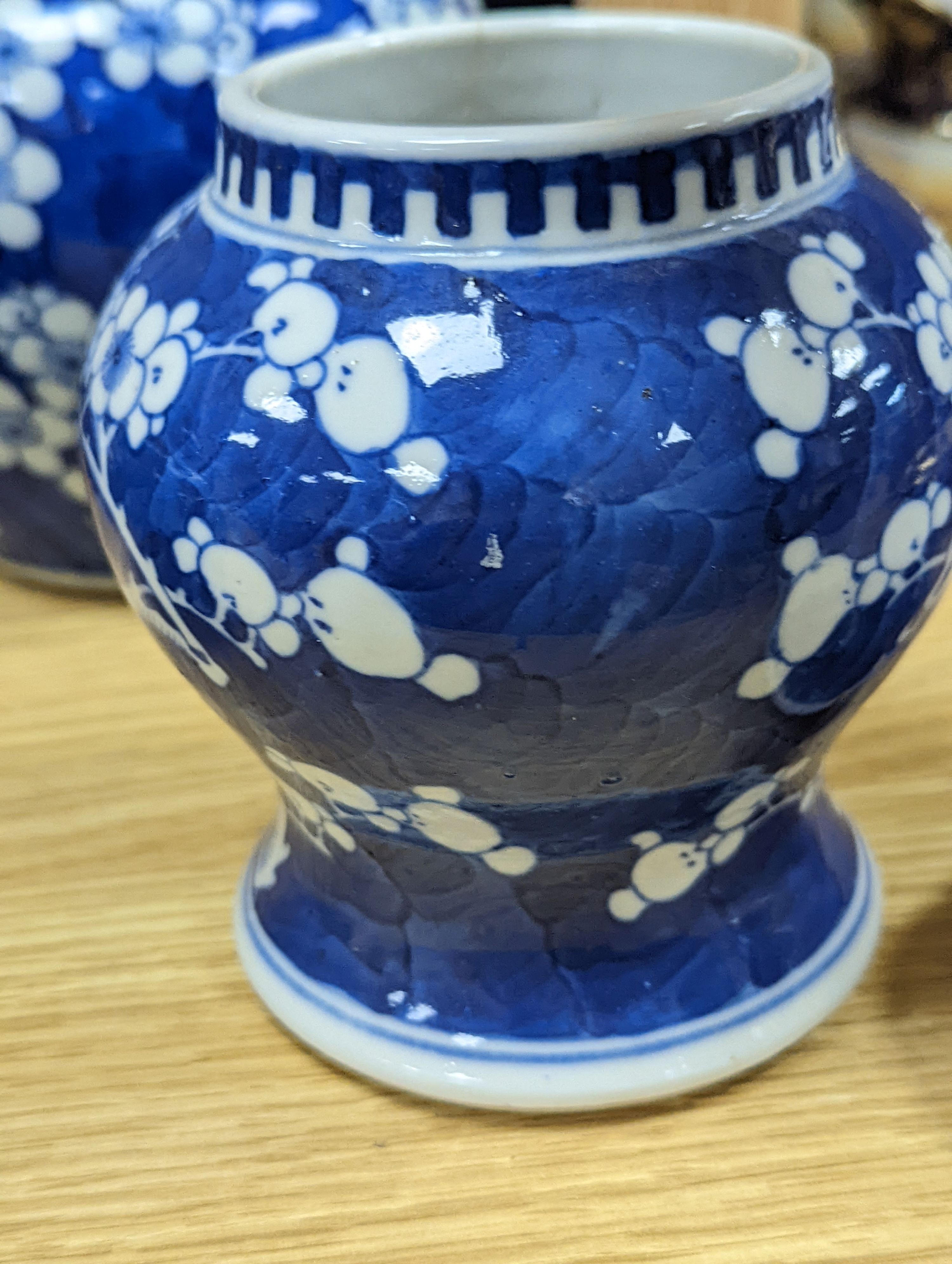 Three Chinese blue and white prunus decorated jars and covers, 19th/20th century, with four character marks 18cm